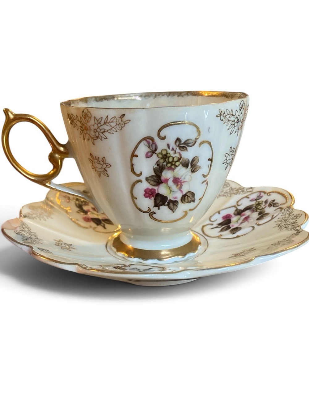 Mid-century iridescent, porcelain tea cup and saucer set rose design